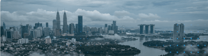 A Southeast Asian financial-district skyline at dusk